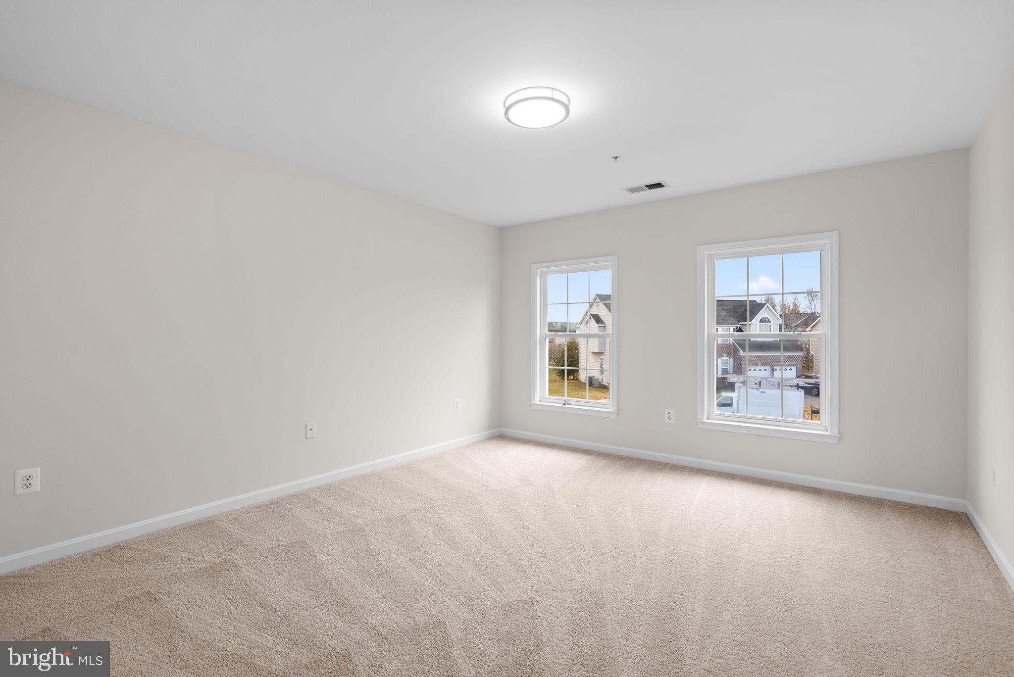 7604 Finglas Court Laurel, MD 20707 - Photo 43 of 48 a view of a big room with windows and chandelier fan