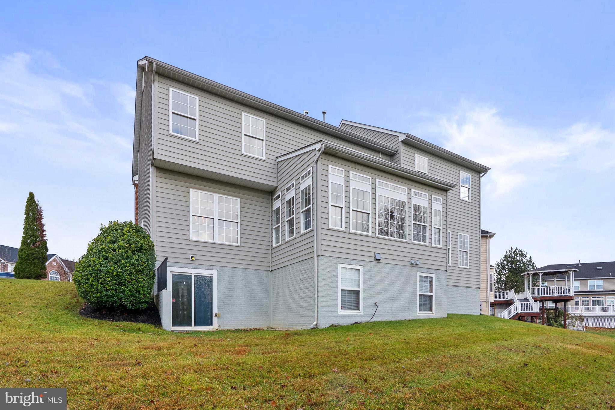 7604 Finglas Court Laurel, MD 20707 - Photo 47 of 48 a large building with a large window and yard