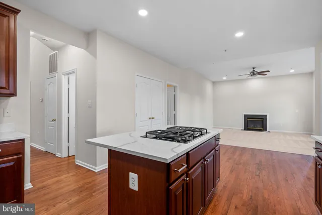 a kitchen that has a sink a stove and a wooden floor