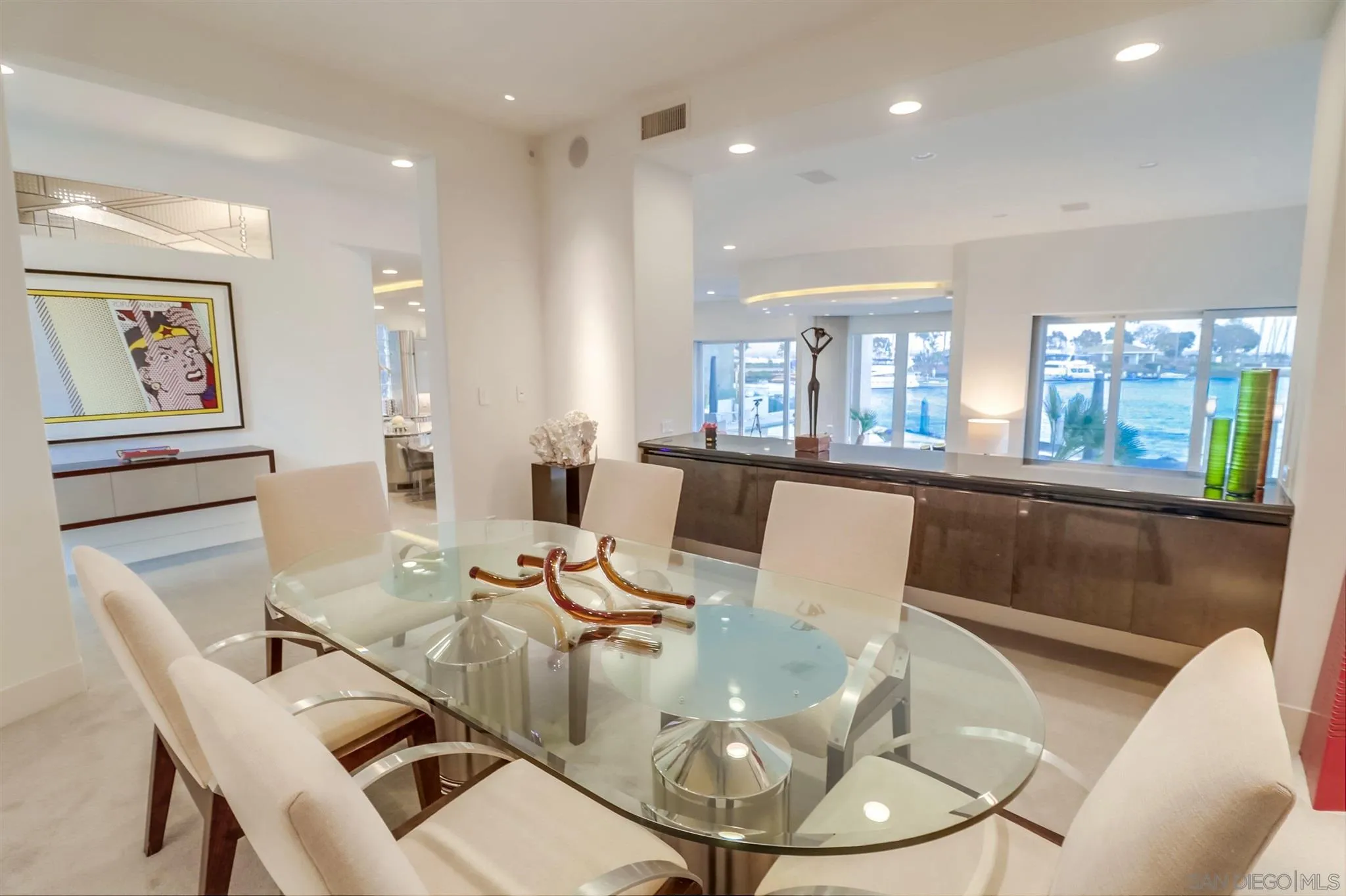 2 Green Turtle Road Coronado, CA 92118 - Photo 4 of 54 a view of a dining room with furniture a kitchen and chandelier