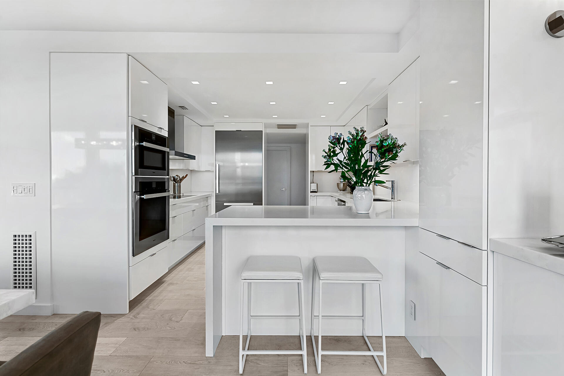 3140 South Ocean Boulevard, Unit 307S Palm Beach, FL 33480 - Photo 10 of 58 a kitchen with kitchen island a counter top space appliances and cabinets