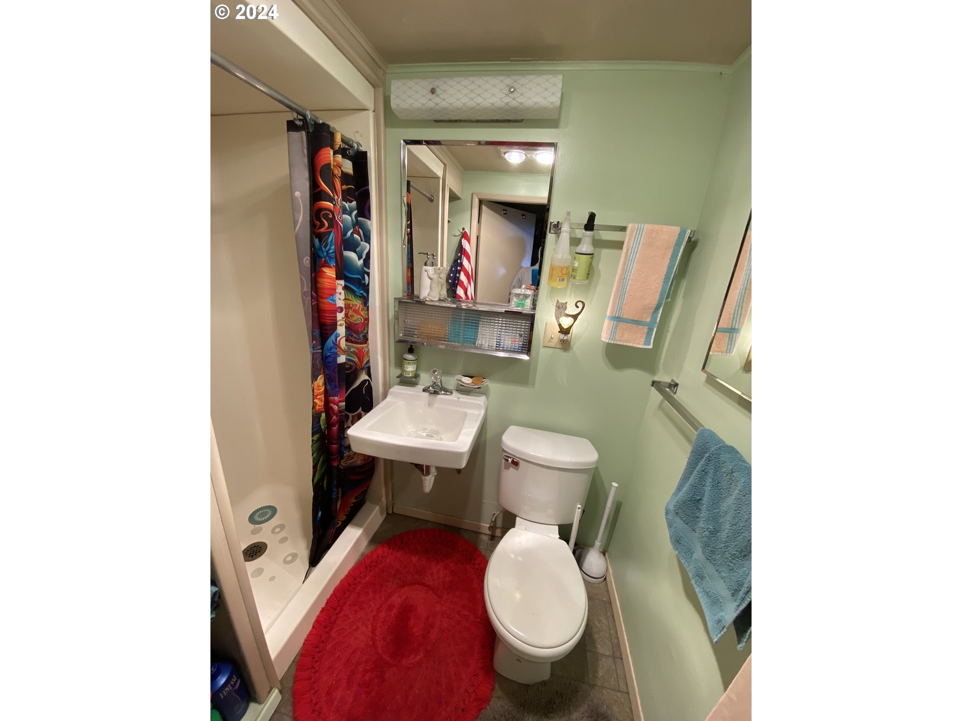 29280 Lacy Street Gold Beach, OR 97444 - Photo 12 of 38 a white toilet sitting next to a bathroom sink