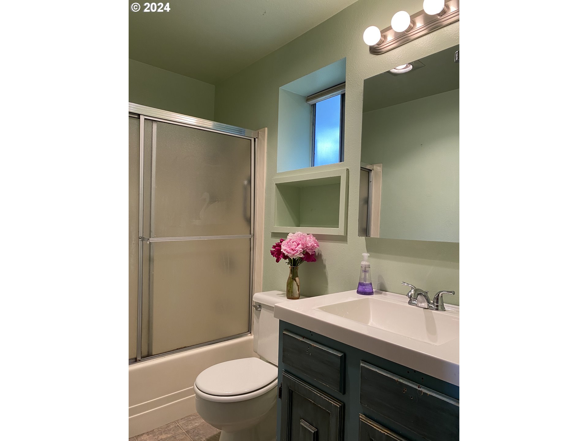 29280 Lacy Street Gold Beach, OR 97444 - Photo 13 of 38 a bathroom with a granite countertop sink a toilet a mirror and shower