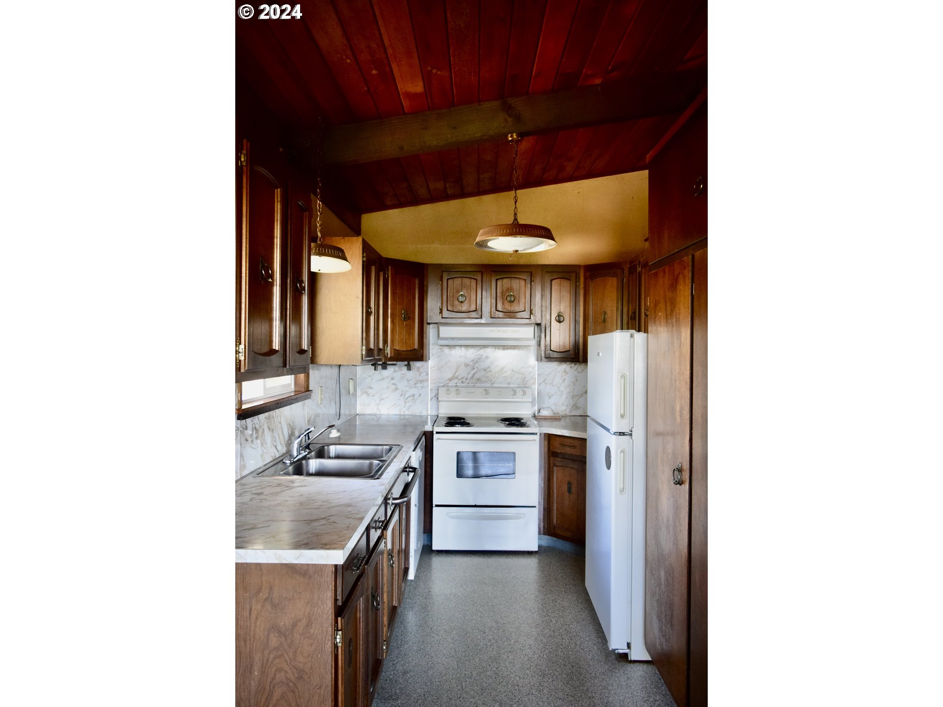 29280 Lacy Street Gold Beach, OR 97444 - Photo 15 of 38 a kitchen with a sink cabinets and stainless steel appliances