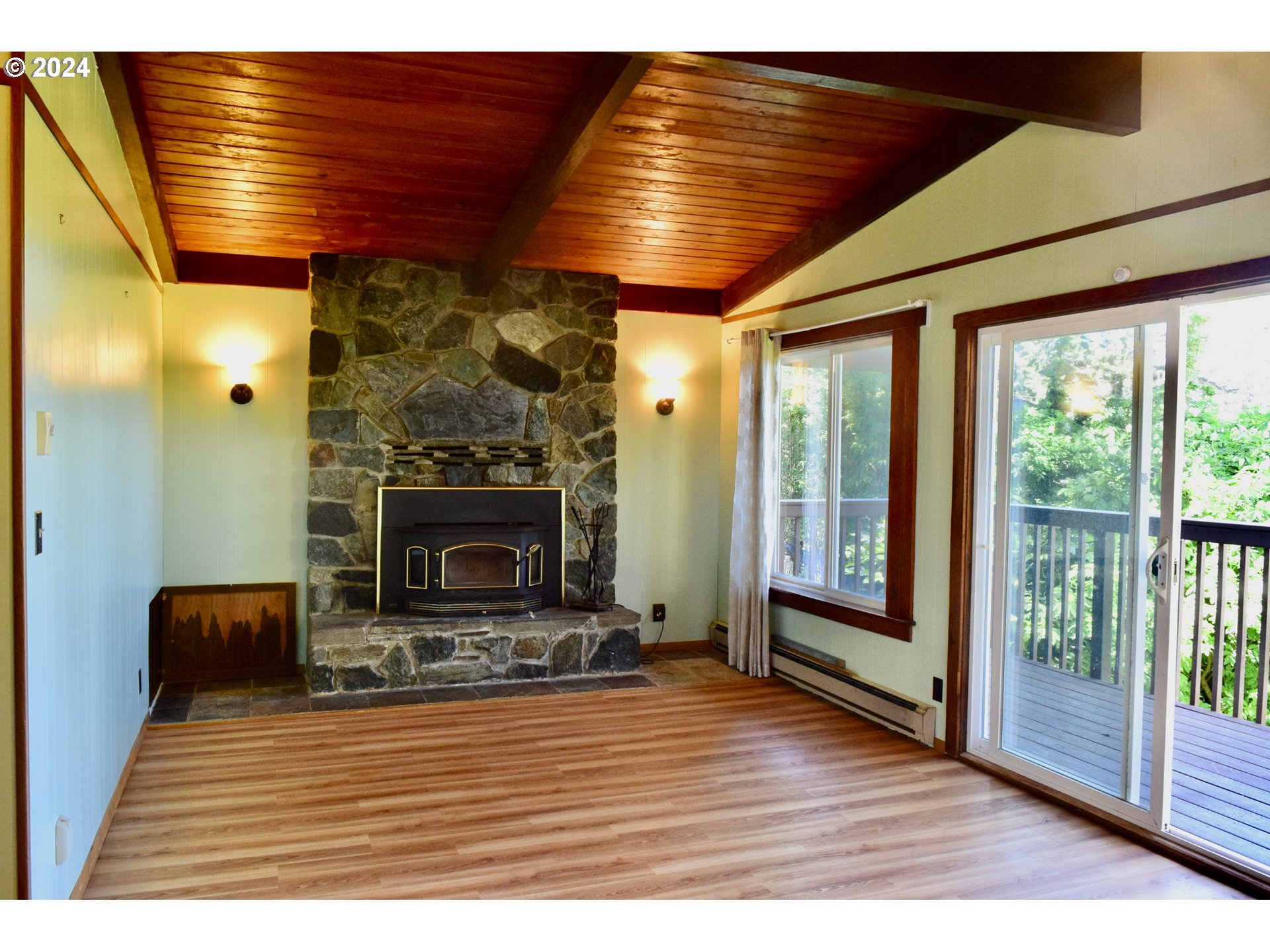 29280 Lacy Street Gold Beach, OR 97444 - Photo 17 of 38 a view of a livingroom with a fireplace and window