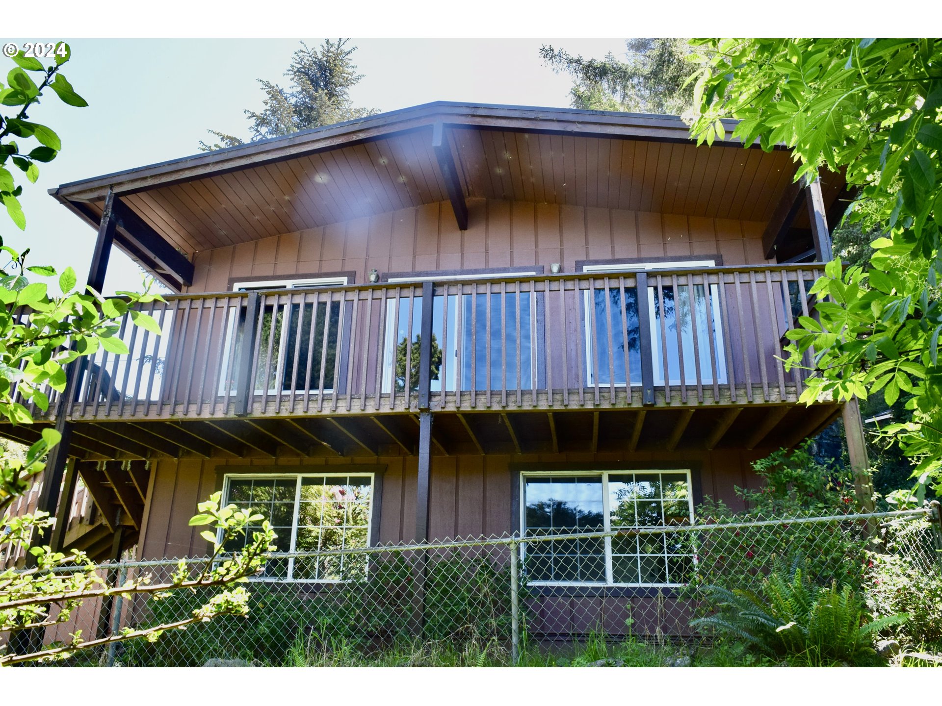 29280 Lacy Street Gold Beach, OR 97444 - Photo 19 of 38 a view of a house with wooden fence