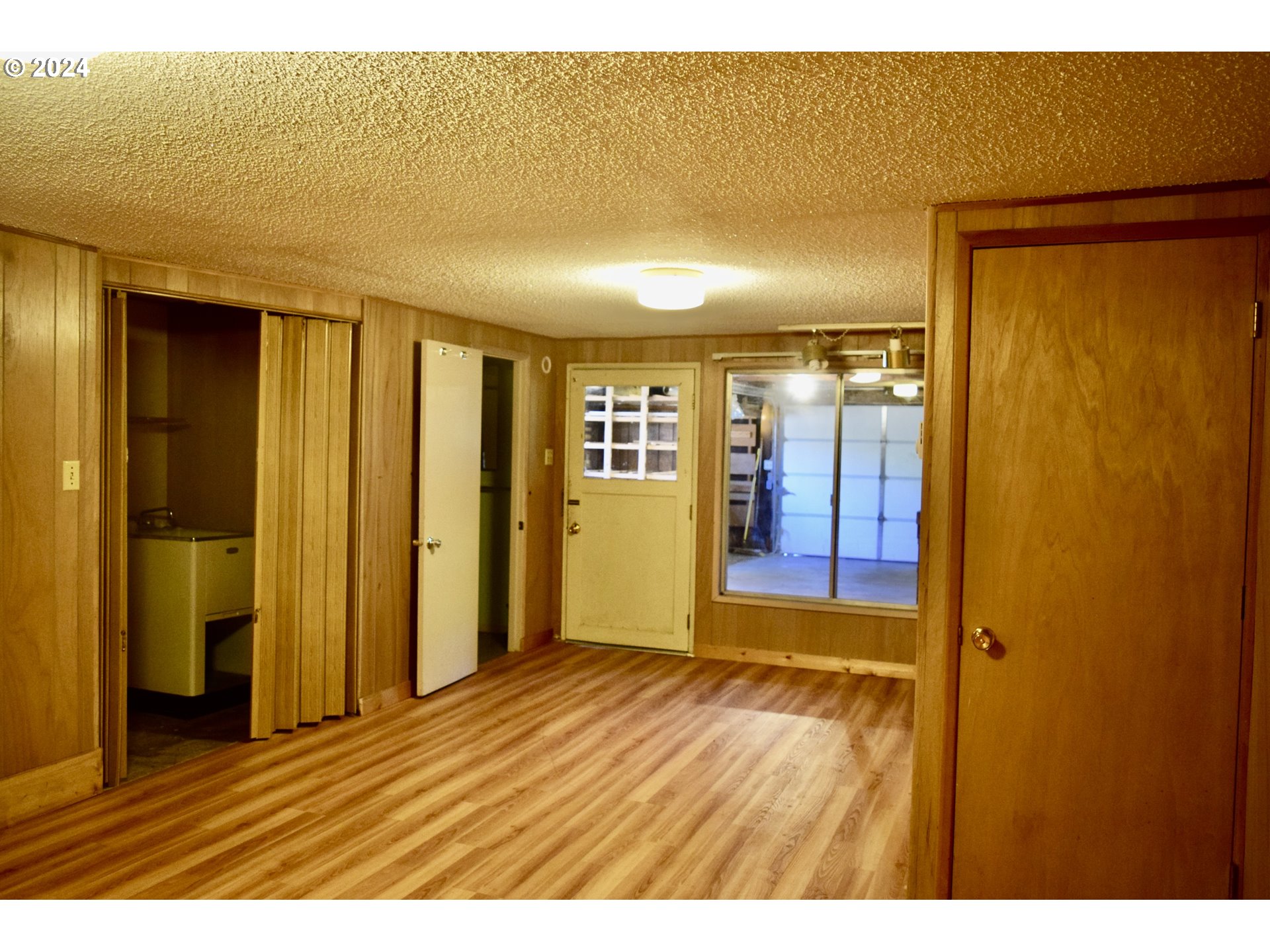 29280 Lacy Street Gold Beach, OR 97444 - Photo 20 of 38 a view of an empty room with window and wooden floor