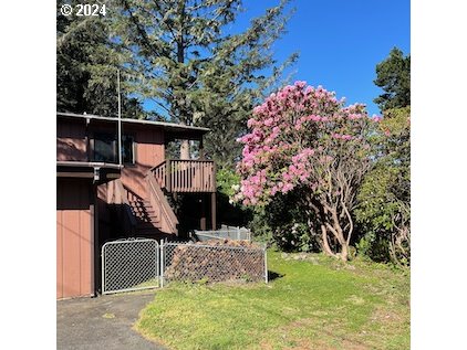 29280 Lacy Street Gold Beach, OR 97444 - Photo 24 of 38 a front view of a house with a yard
