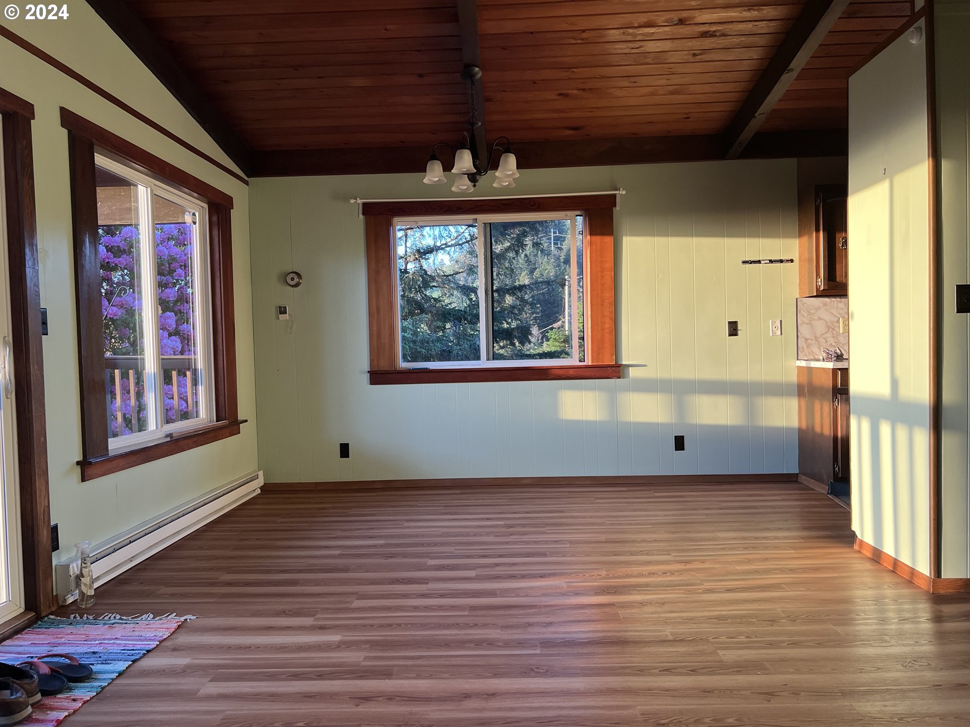 29280 Lacy Street Gold Beach, OR 97444 - Photo 30 of 38 a view of an empty room with a window and wooden floor