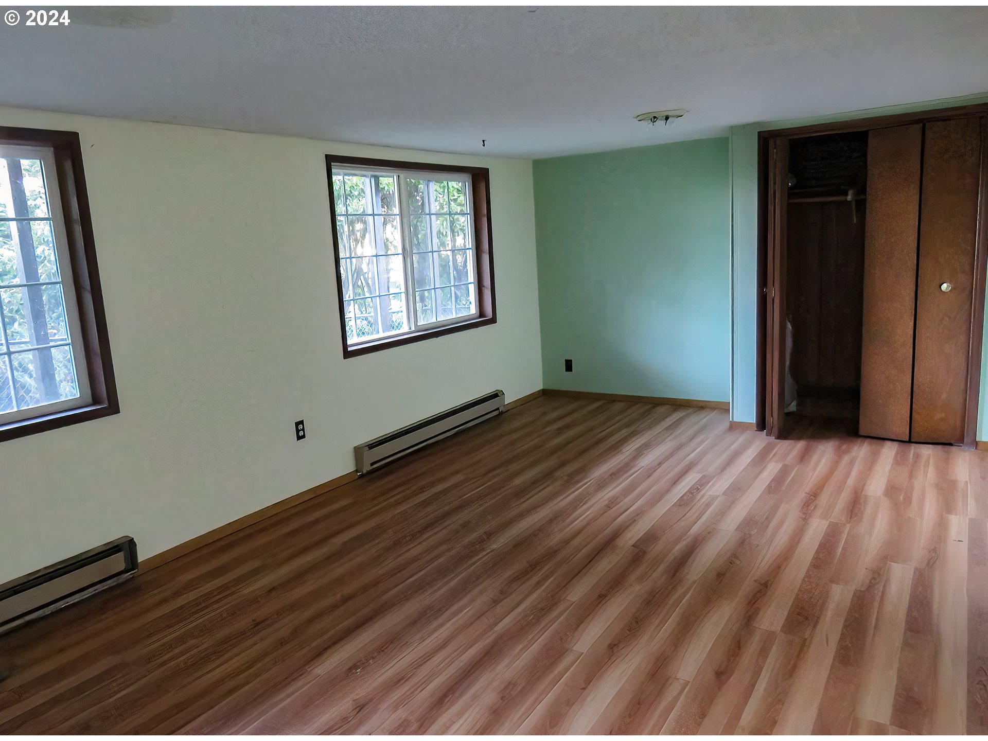 29280 Lacy Street Gold Beach, OR 97444 - Photo 10 of 38 a view of an empty room with wooden floor and a window