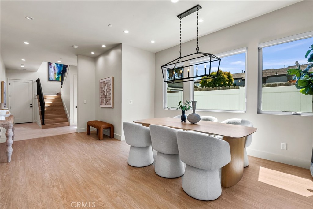 161 Cecil Place, Unit A Costa Mesa, CA 92627 - Photo 18 of 63 a dining room with furniture and wooden floor