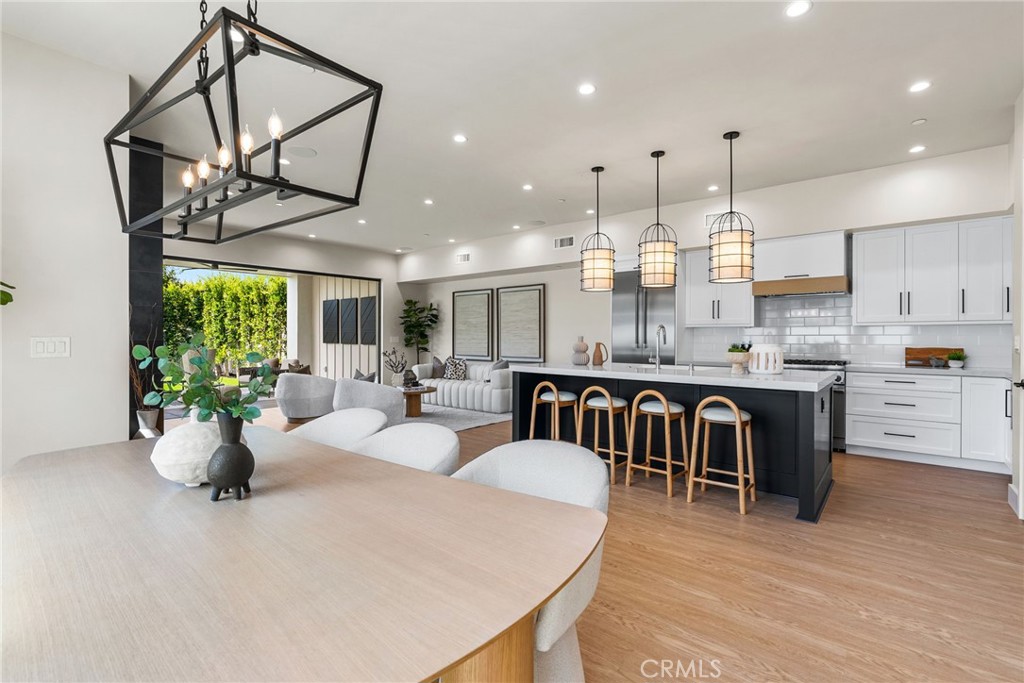 161 Cecil Place, Unit A Costa Mesa, CA 92627 - Photo 19 of 63 a large kitchen with a table and chairs