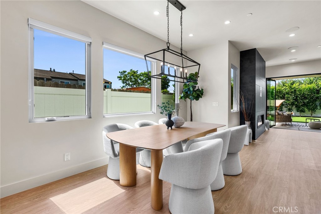 161 Cecil Place, Unit A Costa Mesa, CA 92627 - Photo 20 of 63 a dining room with furniture a window and wooden floor