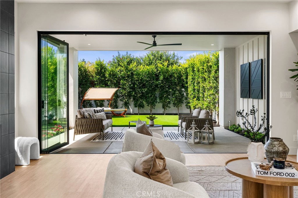 161 Cecil Place, Unit A Costa Mesa, CA 92627 - Photo 24 of 63 a living room with patio furniture and a large window
