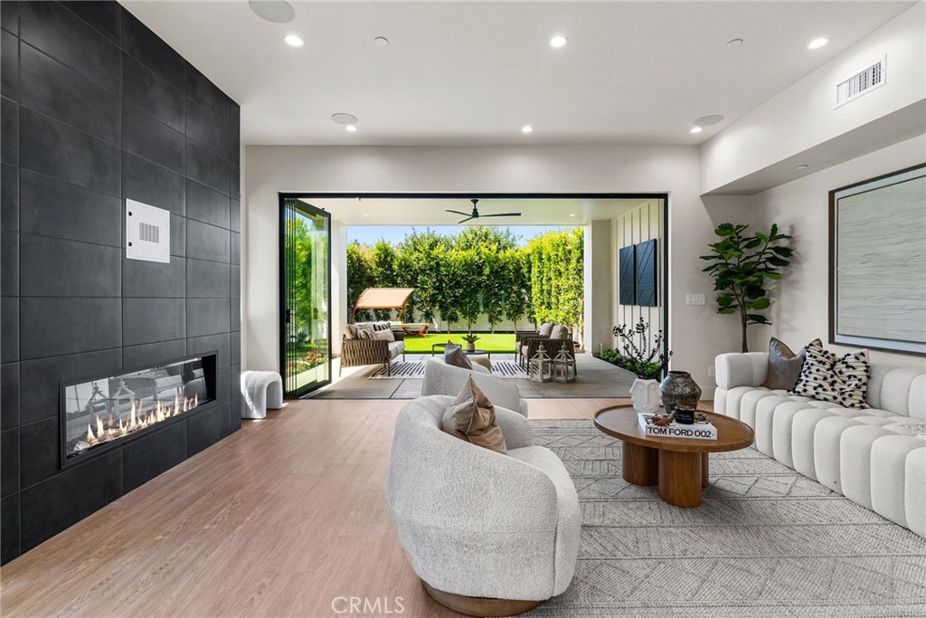 161 Cecil Place, Unit A Costa Mesa, CA 92627 - Photo 25 of 63 a living room with furniture and a floor to ceiling window