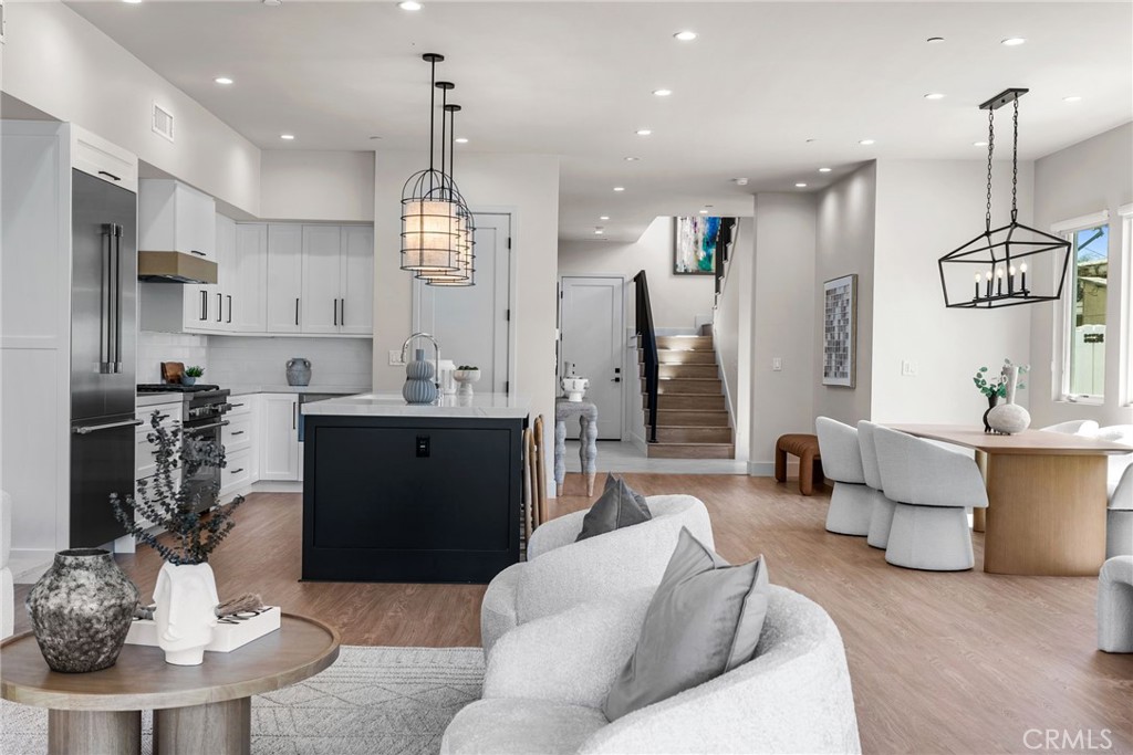 161 Cecil Place, Unit A Costa Mesa, CA 92627 - Photo 31 of 63 a living room with furniture a window and kitchen view