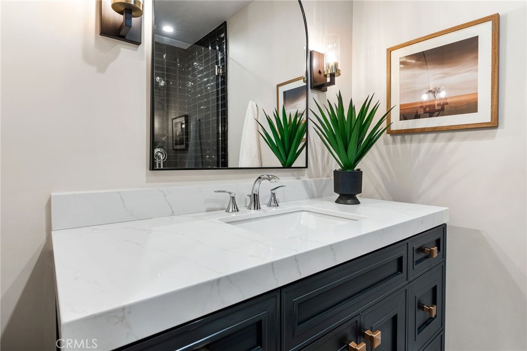 161 Cecil Place, Unit A Costa Mesa, CA 92627 - Photo 35 of 63 a bathroom with a sink and a mirror