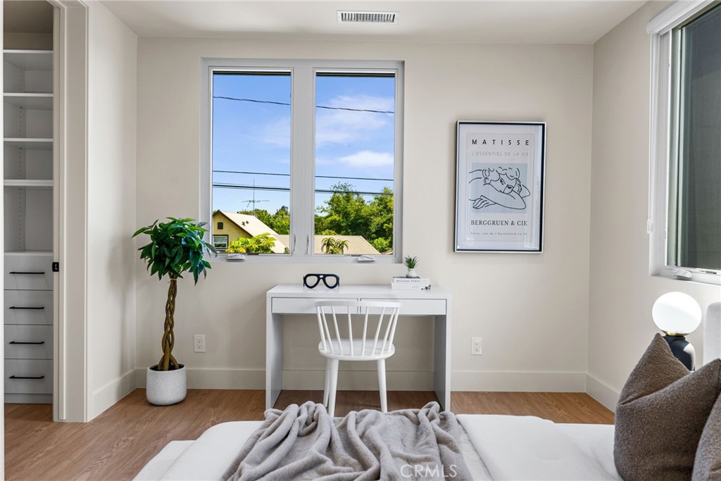 161 Cecil Place, Unit A Costa Mesa, CA 92627 - Photo 45 of 63 a view of a workspace with furniture and a potted plant