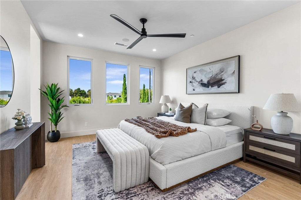 161 Cecil Place, Unit A Costa Mesa, CA 92627 - Photo 5 of 63 a bedroom with a large bed and a couch