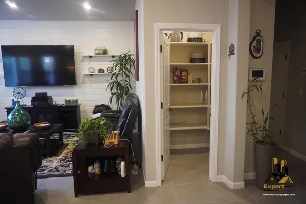 a large kitchen with a table chairs refrigerator and microwave