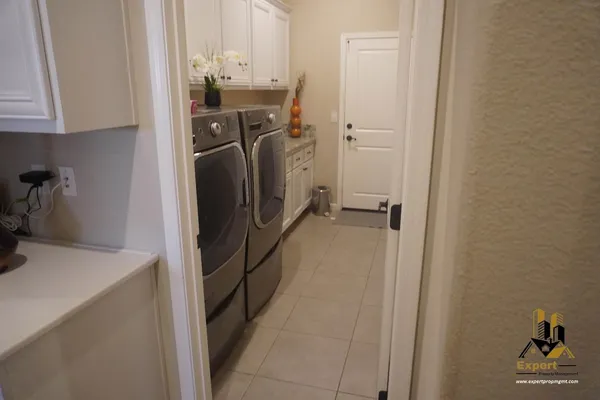 a bathroom with a granite countertop double vanity sink and a mirror