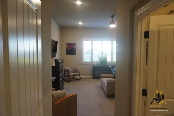 a view of a livingroom with furniture and staircase