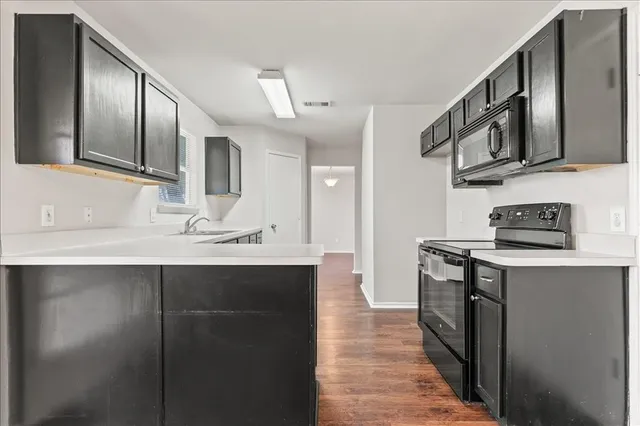 a kitchen with stainless steel appliances granite countertop a sink and a stove