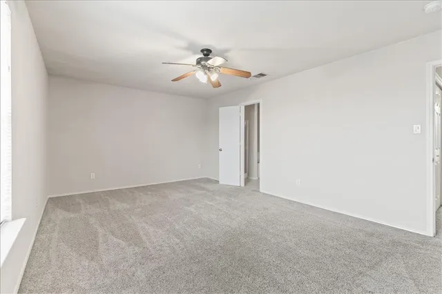 a view of an empty room with a fan