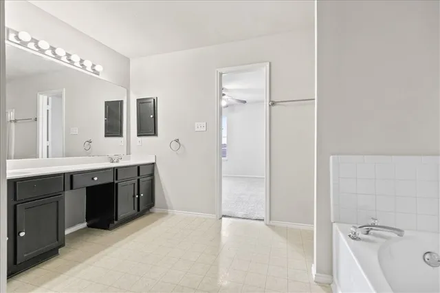a spacious bathroom with a double vanity sink a mirror and a shower