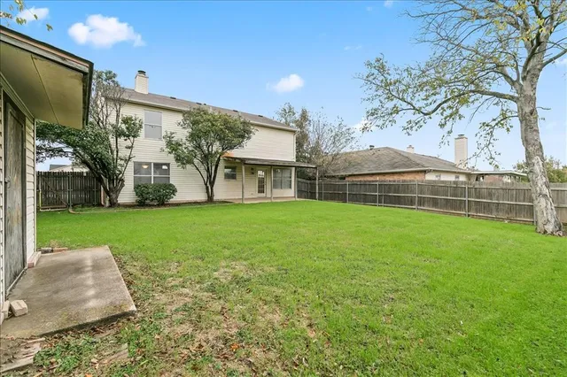 a view of house with backyard