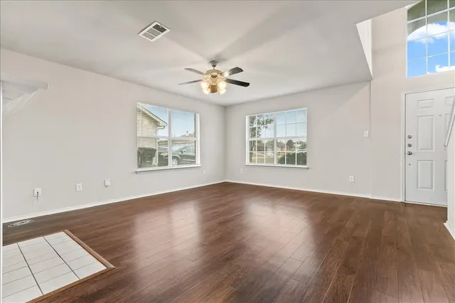 wooden floor in an empty room with a window