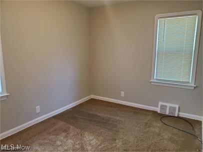 12938 Rockside Road Garfield Heights, OH 44125 - Photo 5 of 9 Bedroom with dark colored carpet and baseboards