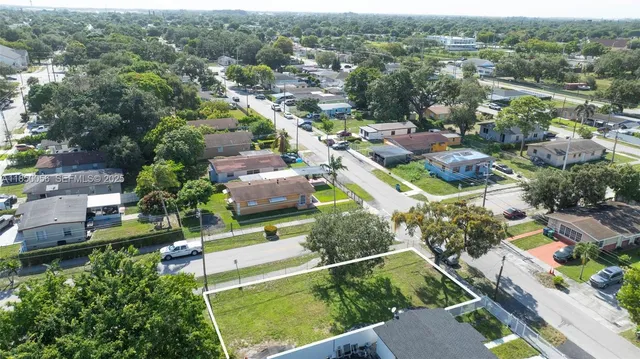 an aerial view of residential houses with outdoor space and street view