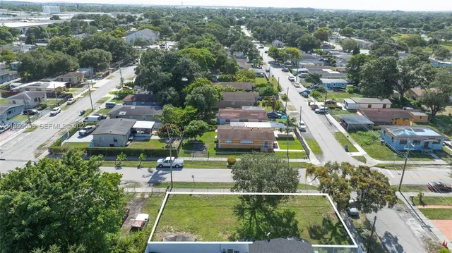 an aerial view of residential houses with outdoor space and swimming pool