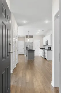 a view of kitchen with refrigerator and window