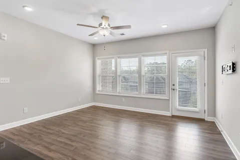 a view of wooden floor and windows in a room