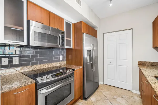 a kitchen that has a sink and a stove in it
