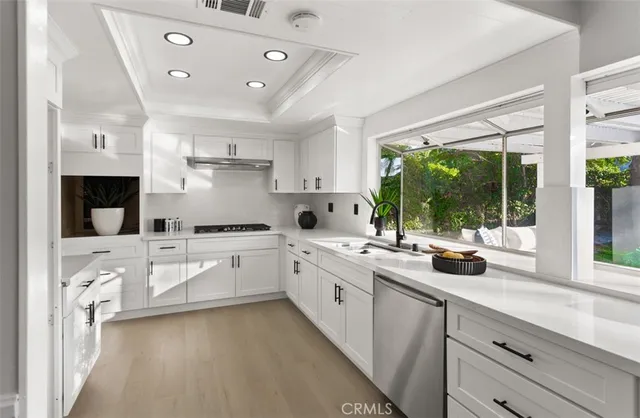 a kitchen with a sink stove and microwave