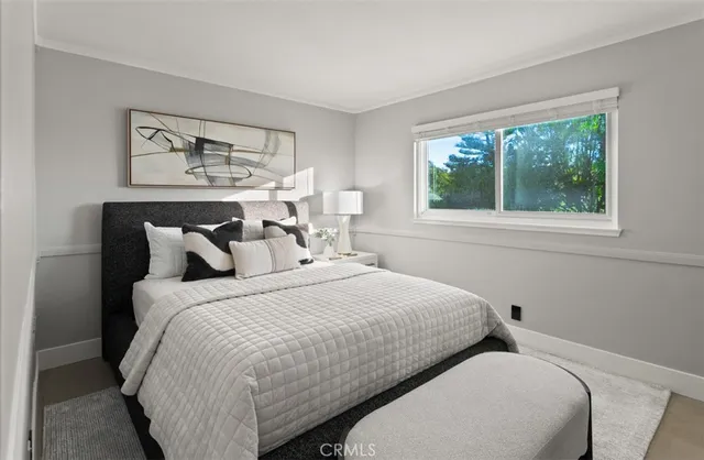 a bedroom with a bed and a couch