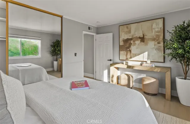 a kitchen with a potted plant on the counter and cabinets
