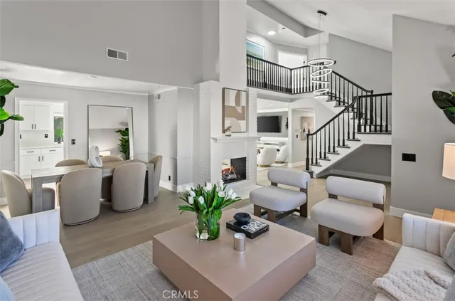 a living room with furniture potted plant and a chandelier