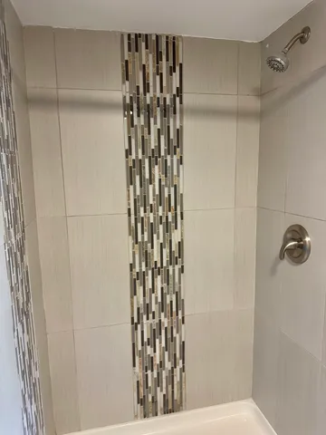 a bathroom with a sink vanity granite and a mirror