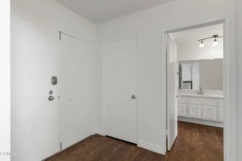 a view of bathroom with a sink mirror and window