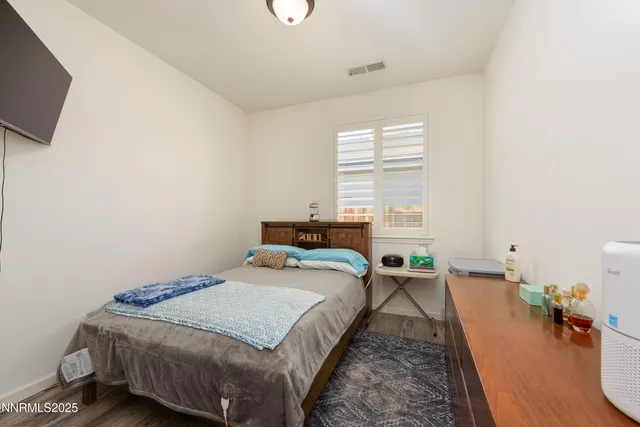 a bed room with a bed and a television