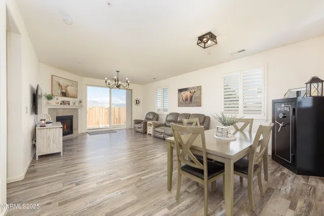 a dining room with furniture a window and wooden floor