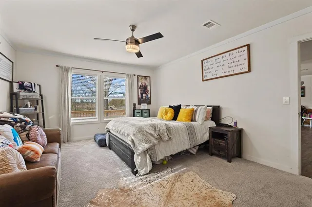 a spacious bedroom with a bed and a couch