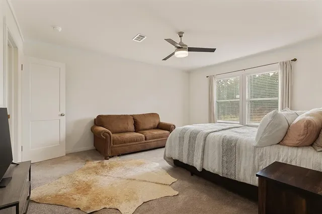 a living room with a bed furniture and a window
