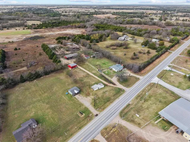 an aerial view of residential houses with outdoor space