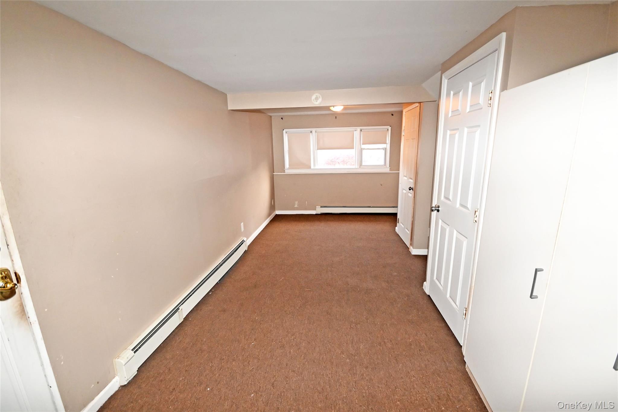 89 Osborne Road West Hempstead, NY 11552 - Photo 40 of 50 Hall with a baseboard heating unit and carpet flooring