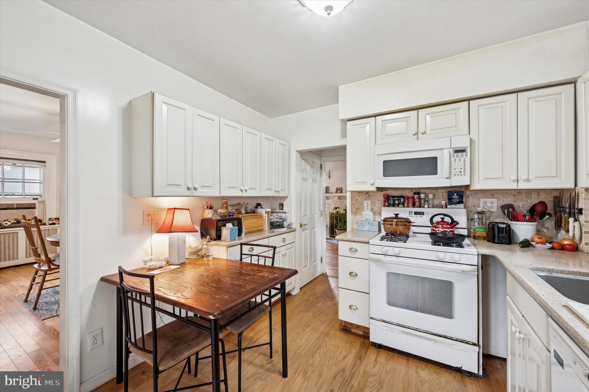 15 Oakland Road Broomall, PA 19008 - Photo 13 of 27 a kitchen with white cabinets and white appliances